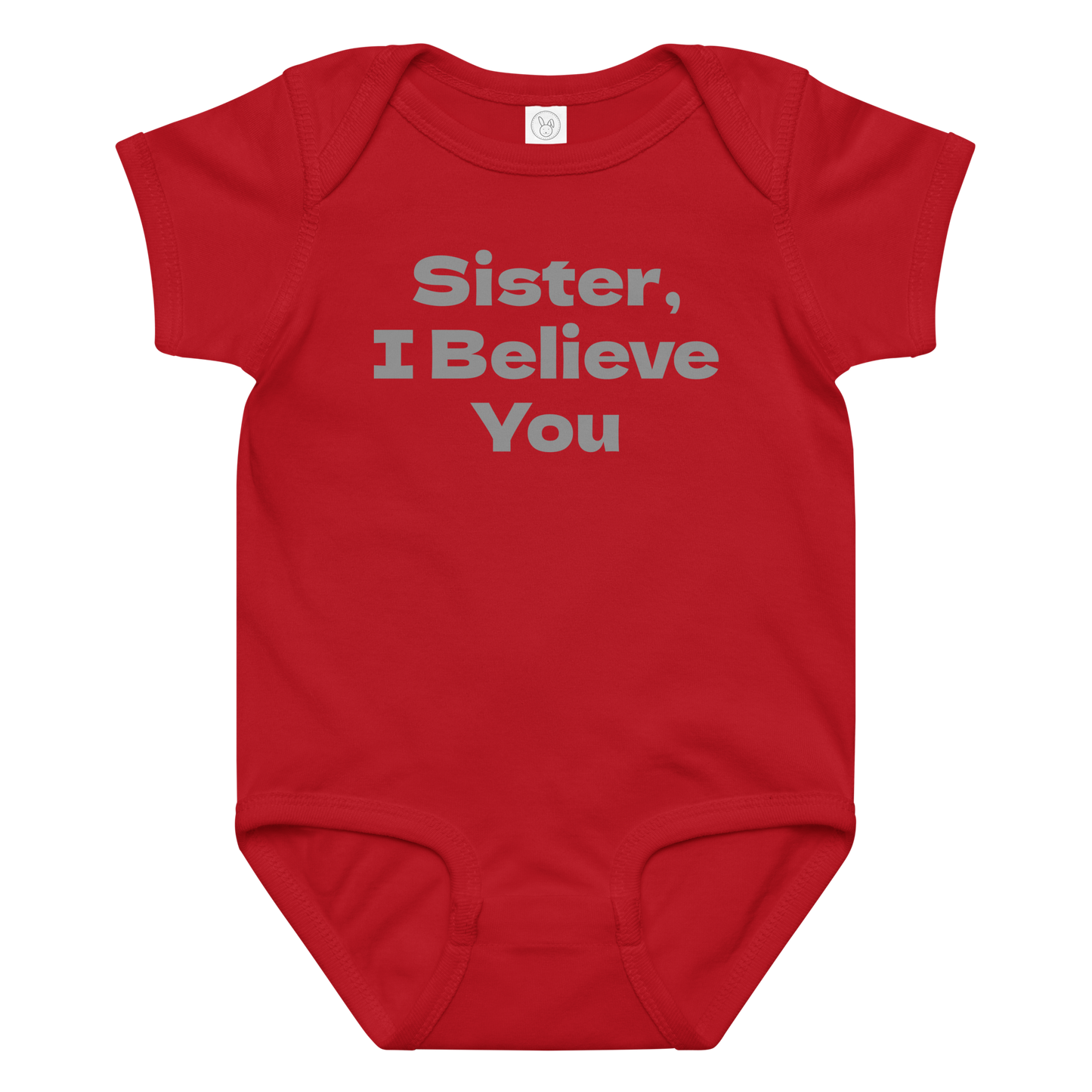 "Sister, I Believe You!" printed on a red baby jersey bodysuit laying on a flat surface amongst other clothes
