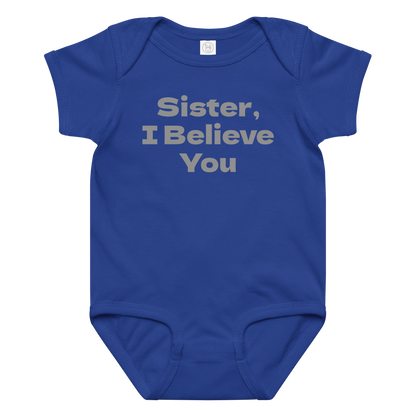 "Sister, I Believe You!" printed on a royal baby jersey bodysuit laying on a flat surface amongst other clothes