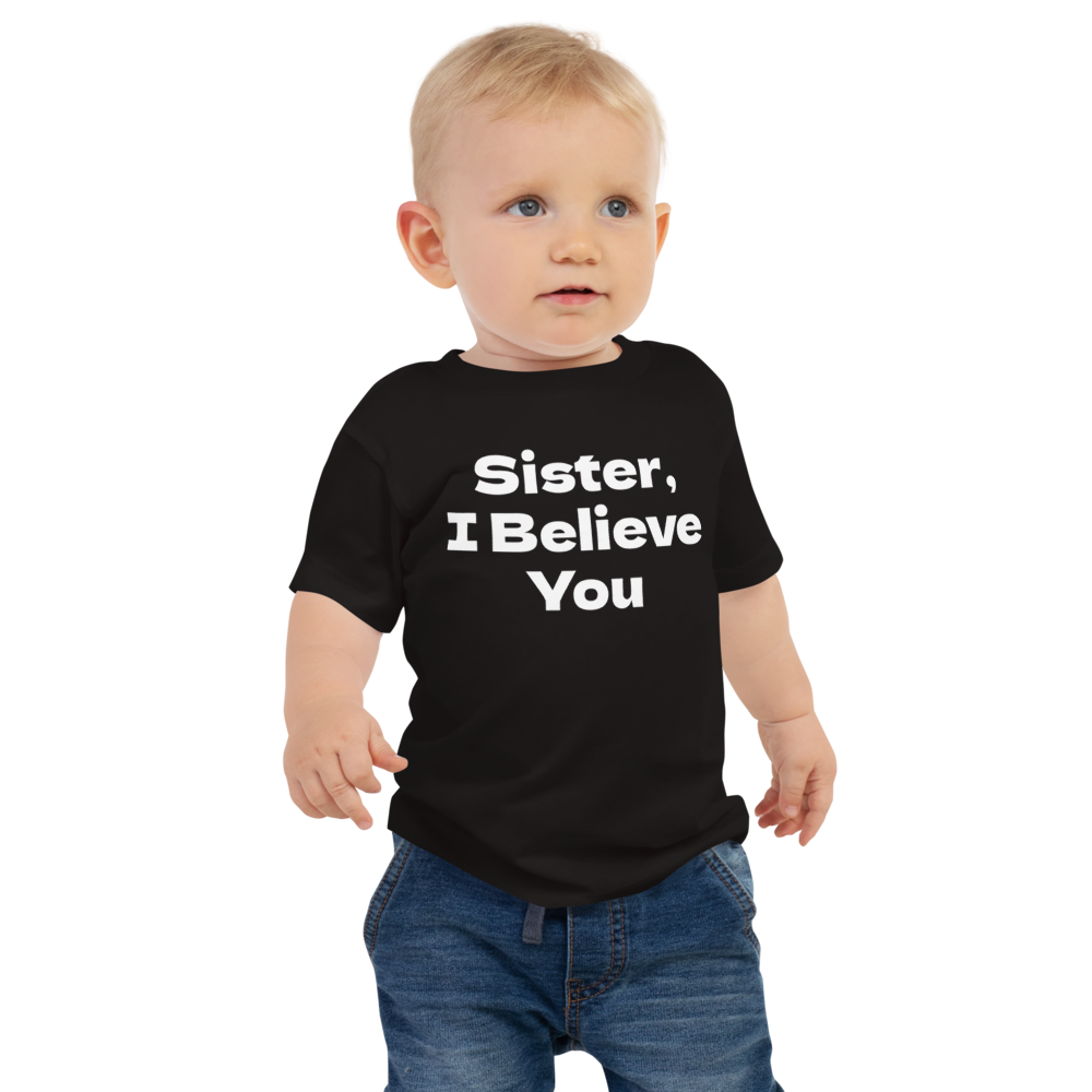 "Sister, I Believe You!" printed on a black baby jersey short sleeve tee worn by a male