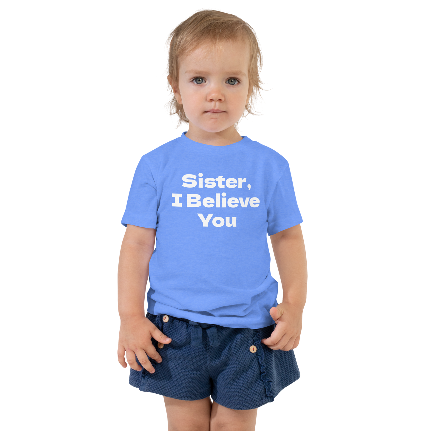 "Sister, I Believe You!" printed on a heather columbia blue toddler short sleeve tee worn by a female