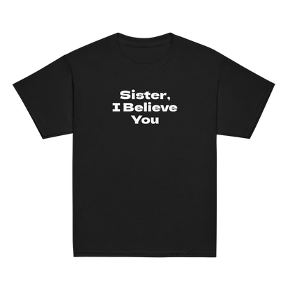 "Sister, I Believe You!" printed on a black youth classic tee laying on a flat surface