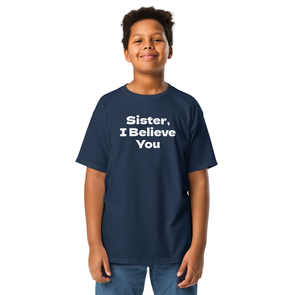 "Sister, I Believe You!" printed on a navy youth classic tee worn by a male