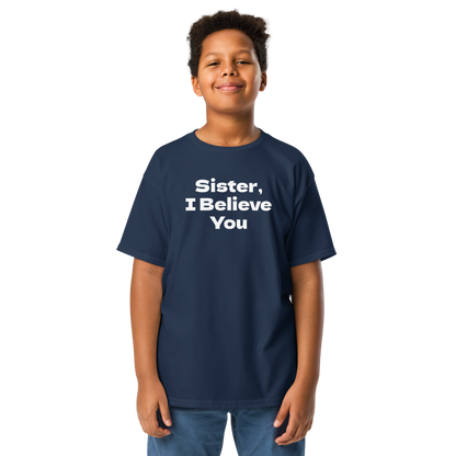 "Sister, I Believe You!" printed on a navy youth classic tee worn by a male