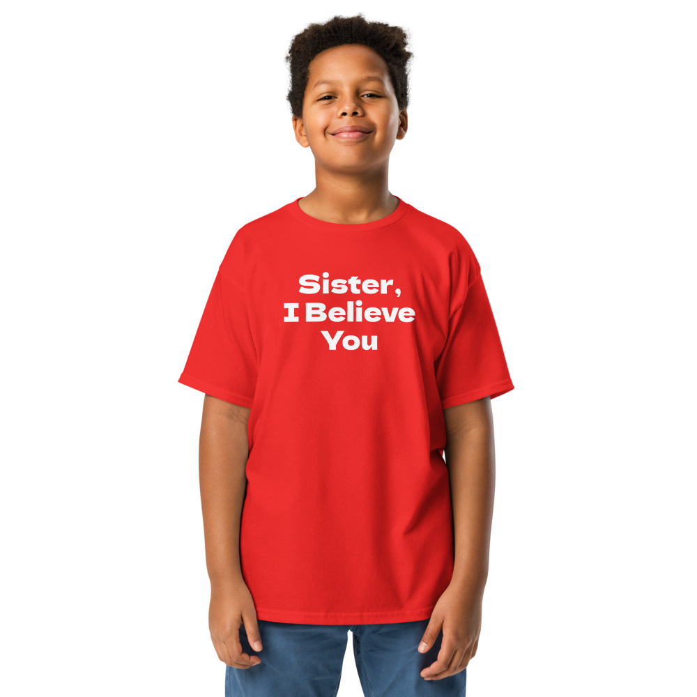 "Sister, I Believe You!" printed on a red youth classic tee worn by a male