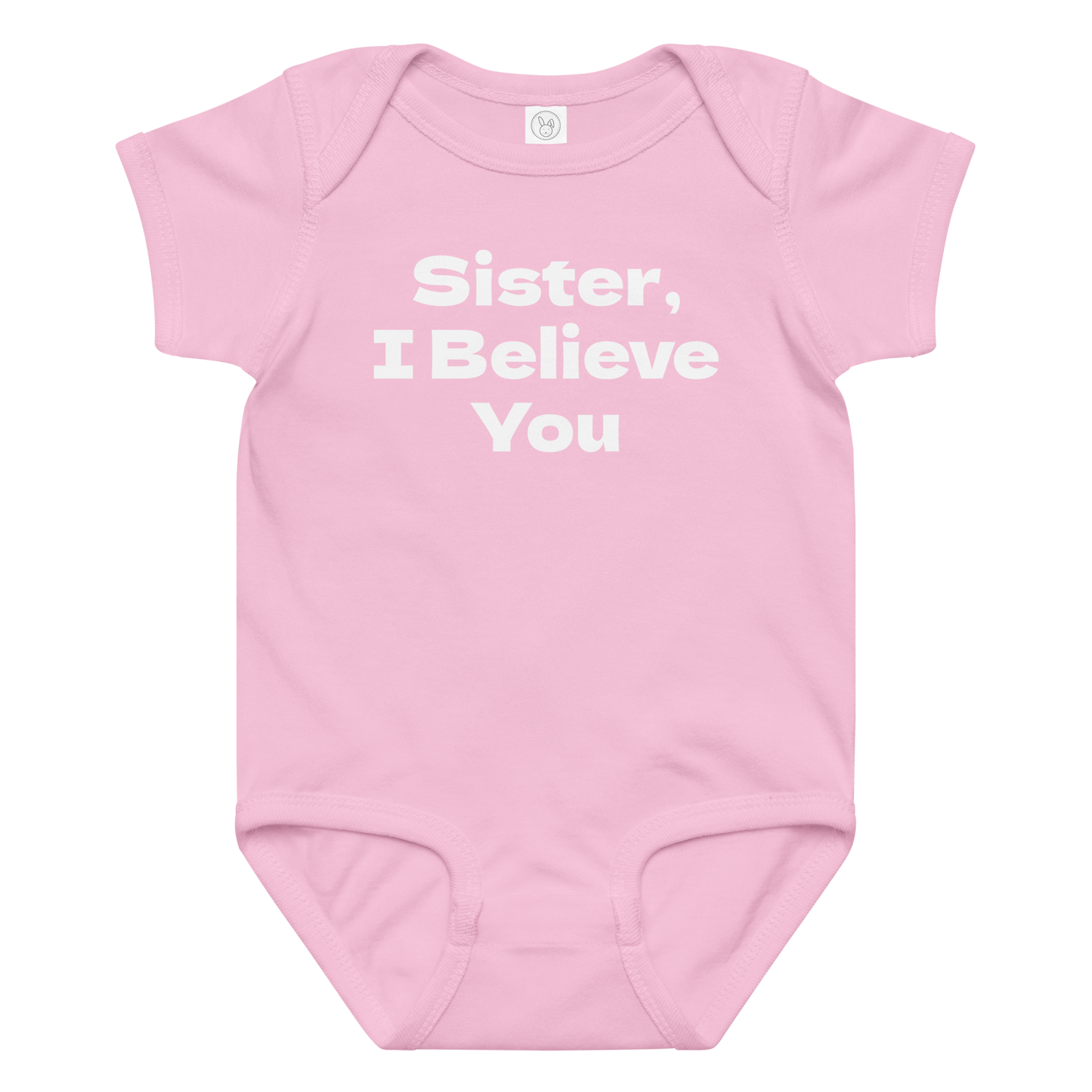 "Sister, I Believe You!" printed on a pink baby jersey bodysuit laying on a flat surface amongst other clothes