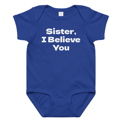 "Sister, I Believe You!" printed on a royal baby jersey bodysuit laying on a flat surface amongst other clothes