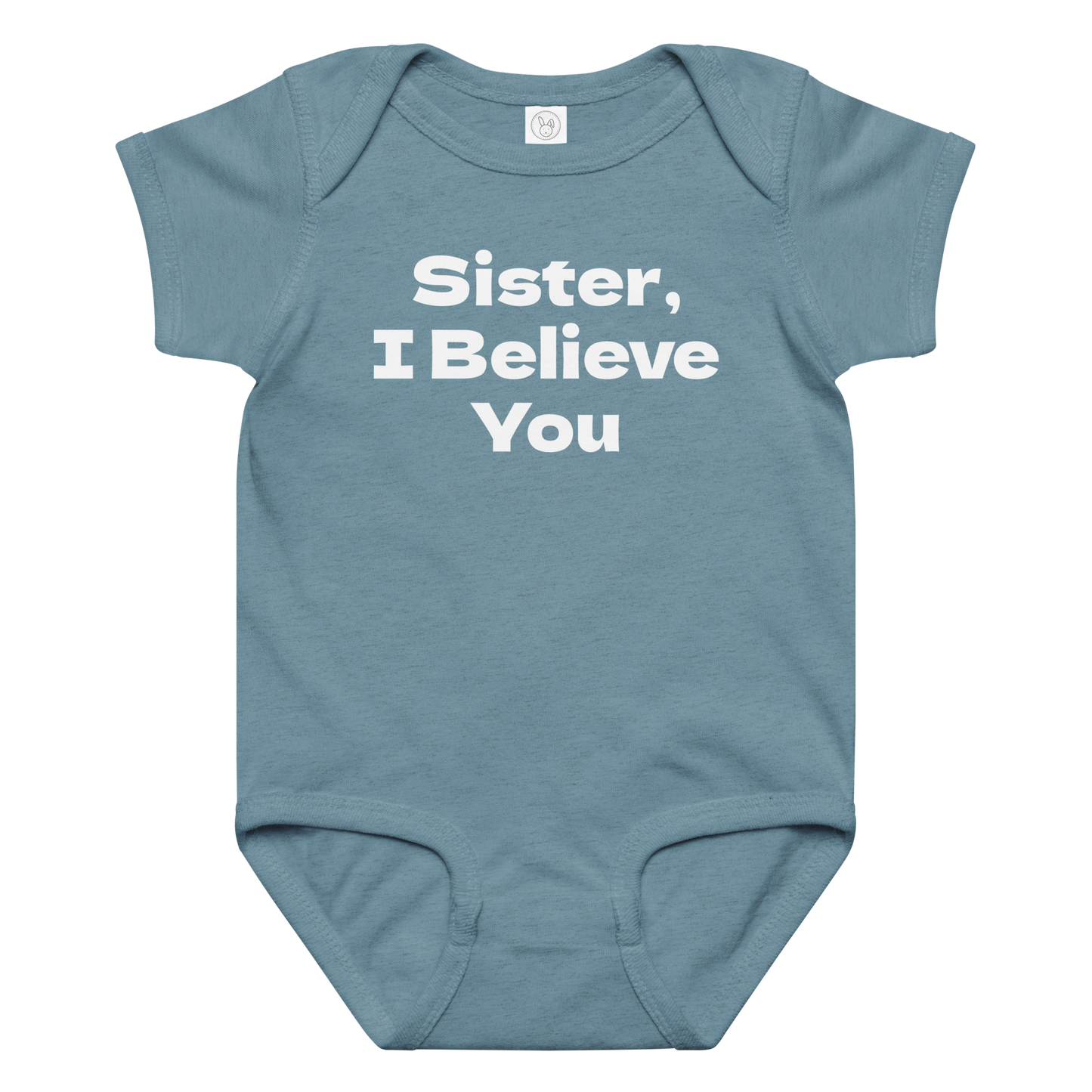 "Sister, I Believe You!" printed on a vintage indigo baby jersey bodysuit laying on a flat surface amongst other clothes
