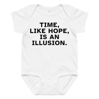 "Time, like hope, is an illusion" printed on a white baby jersey bodysuit laying on a flat surface amongst other clothes