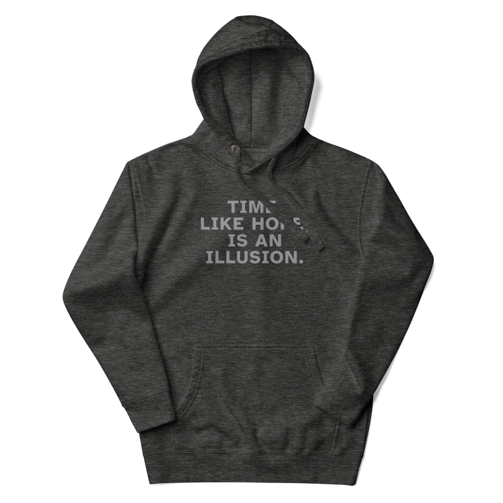 "Time, like hope, is an illusion" printed on a charcoal heather unisex hoodie laying on a flat surface with the hood up