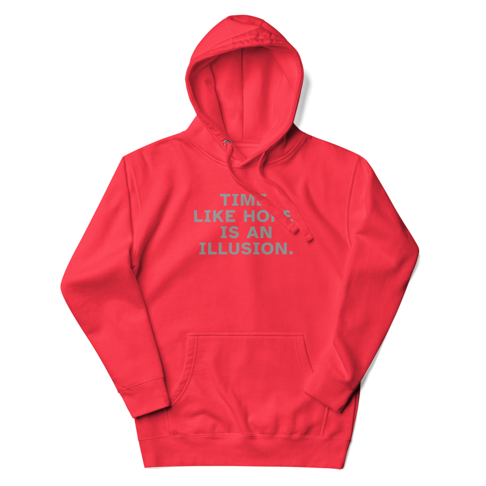 "Time, like hope, is an illusion" printed on a team red unisex hoodie laying on a flat surface with the hood up
