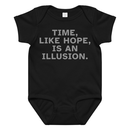 "Time, like hope, is an illusion" printed on a black baby jersey bodysuit laying on a flat surface amongst other clothes