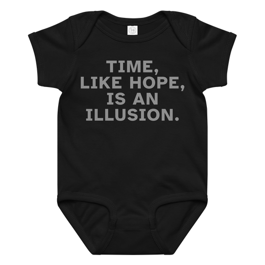 "Time, like hope, is an illusion" printed on a black baby jersey bodysuit laying on a flat surface amongst other clothes