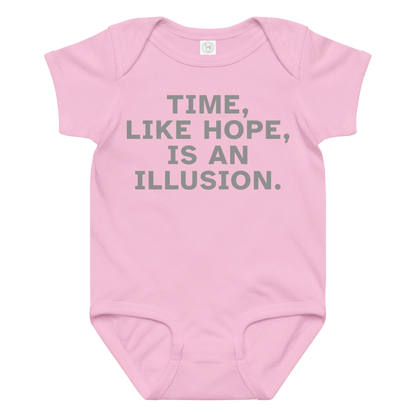 "Time, like hope, is an illusion" printed on a pink baby jersey bodysuit laying on a flat surface amongst other clothes