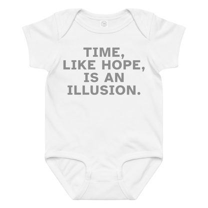 "Time, like hope, is an illusion" printed on a white baby jersey bodysuit laying on a flat surface amongst other clothes
