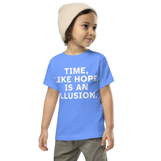 "Time, like hope, is an illusion" printed on a heather columbia blue toddler short sleeve tee worn by a male wearing a cap