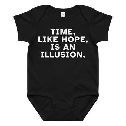 "Time, like hope, is an illusion" printed on a black baby jersey bodysuit laying on a flat surface amongst other clothes