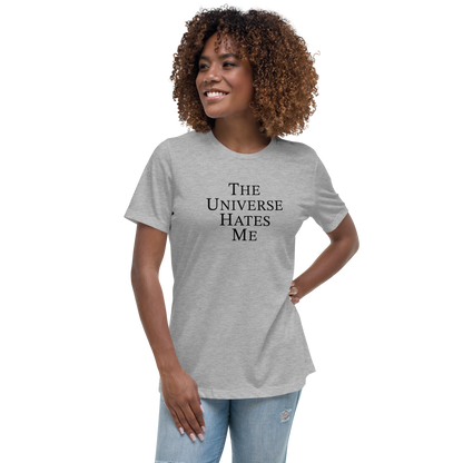 "The Universe Hates Me" printed on a athletic heather women's relaxed t-shirt worn by a female