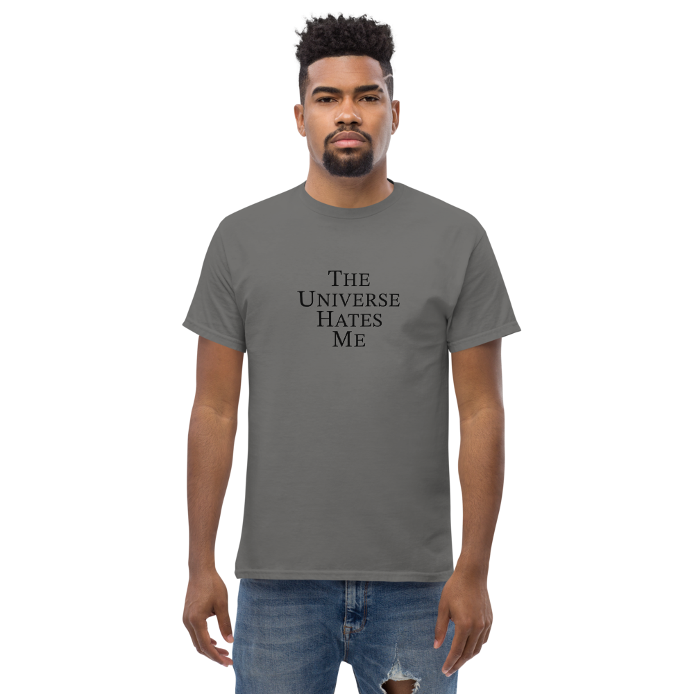 "The Universe Hates Me" printed on a charcoal unisex classic tee worn by a male
