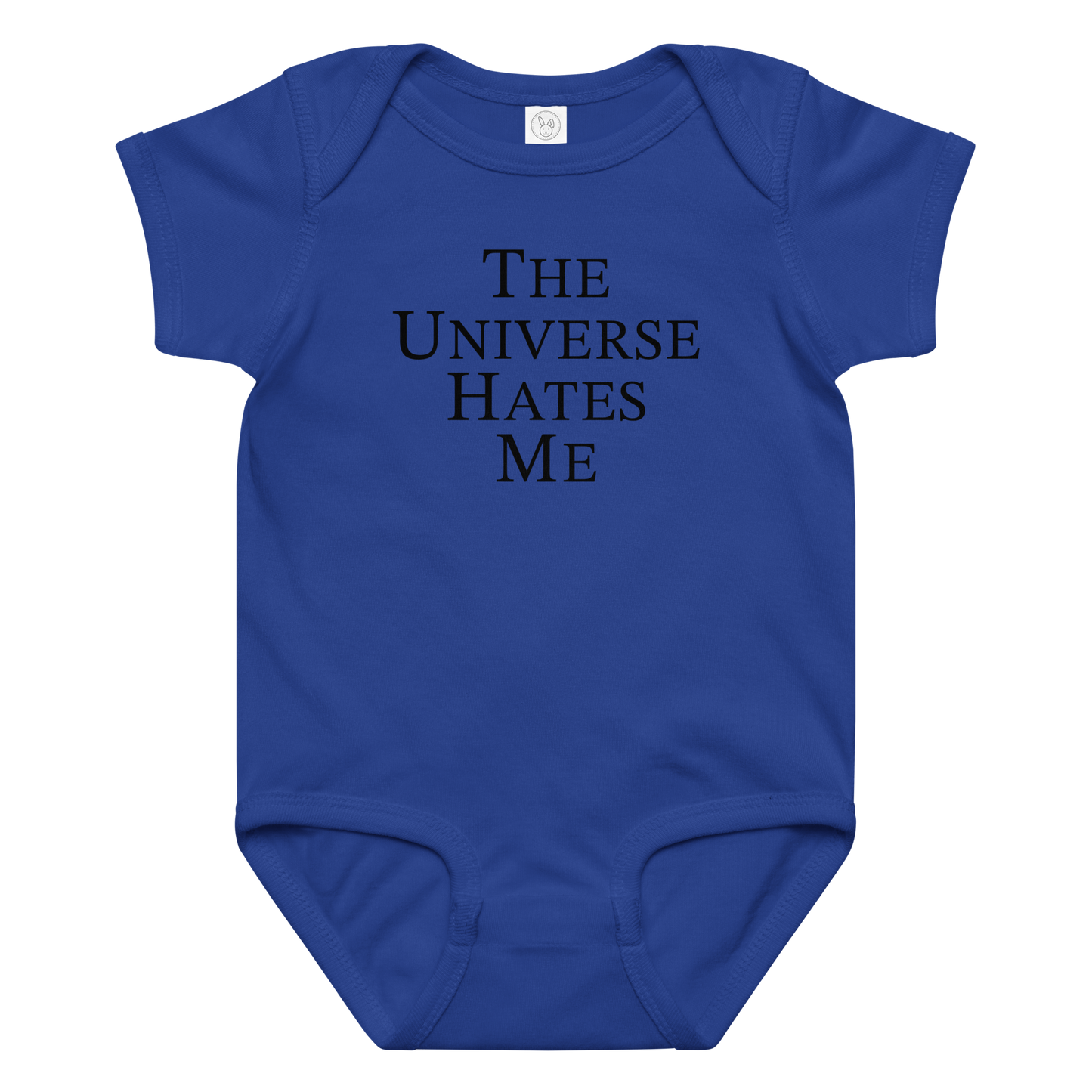 "The Universe Hates Me" printed on a royal baby jersey bodysuit laying on a flat surface amongst other clothes