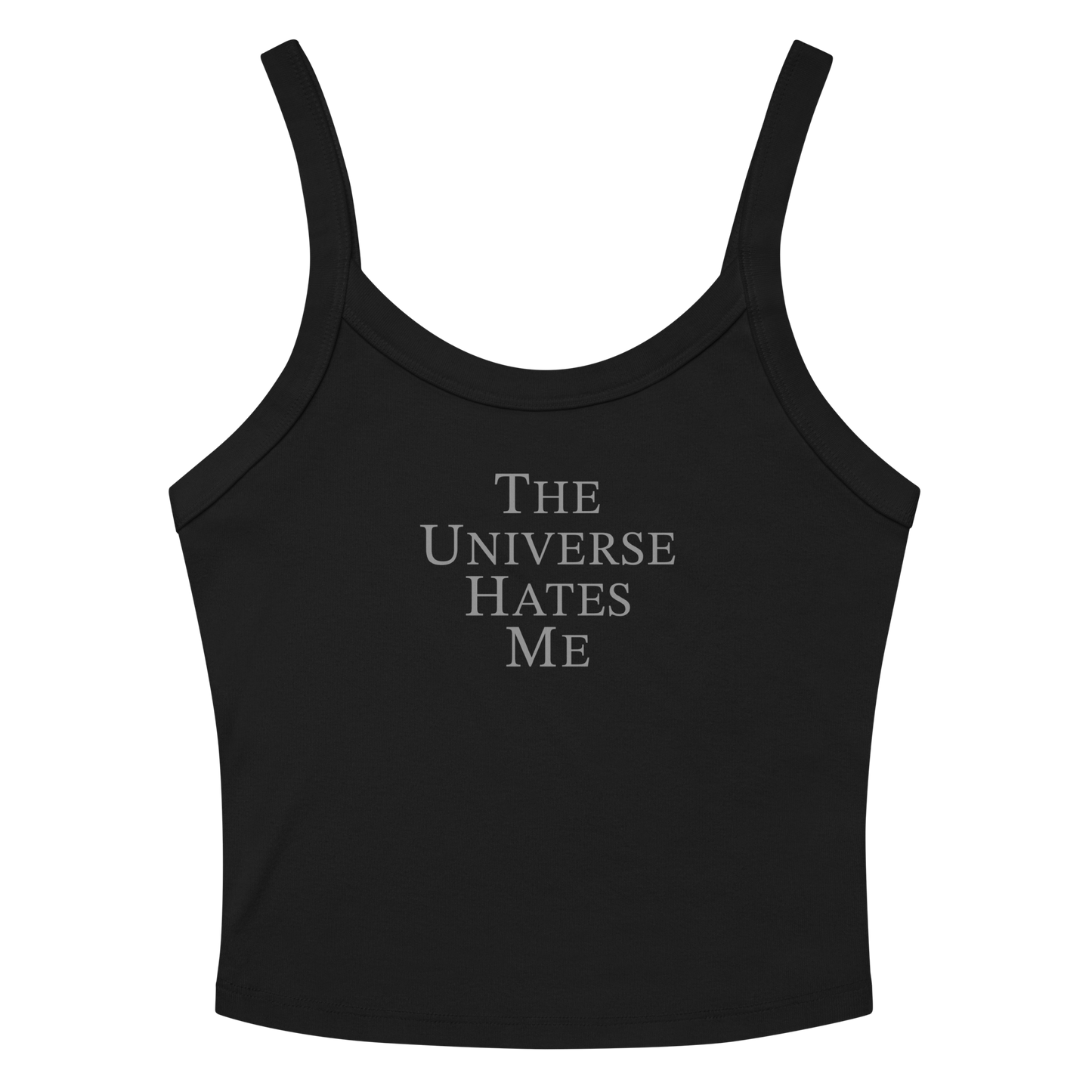 "The Universe Hates Me" printed on a solid black blend women's micro-rib tanktop laying on a flat surface amongst sunglasses and shorts