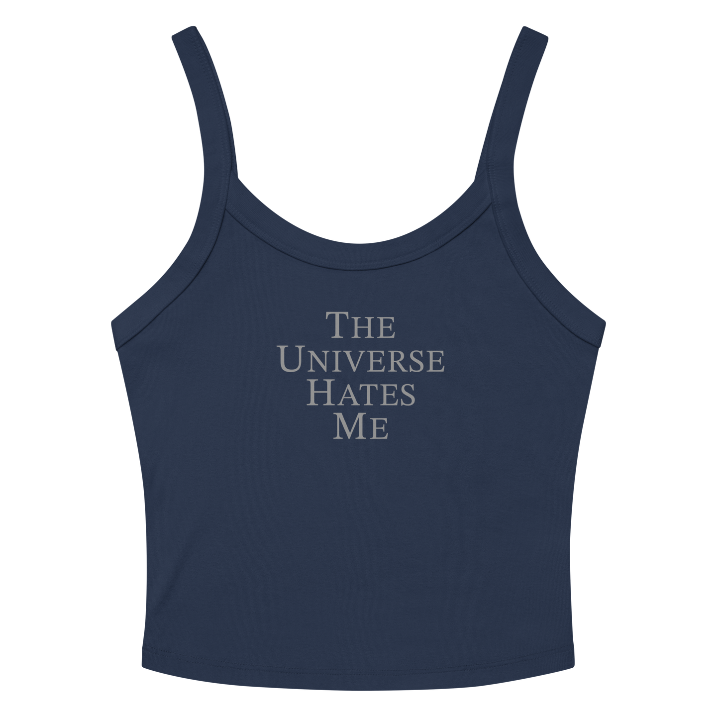 "The Universe Hates Me" printed on a solid navy blend women's micro-rib tanktop laying on a flat surface amongst sunglasses and shorts
