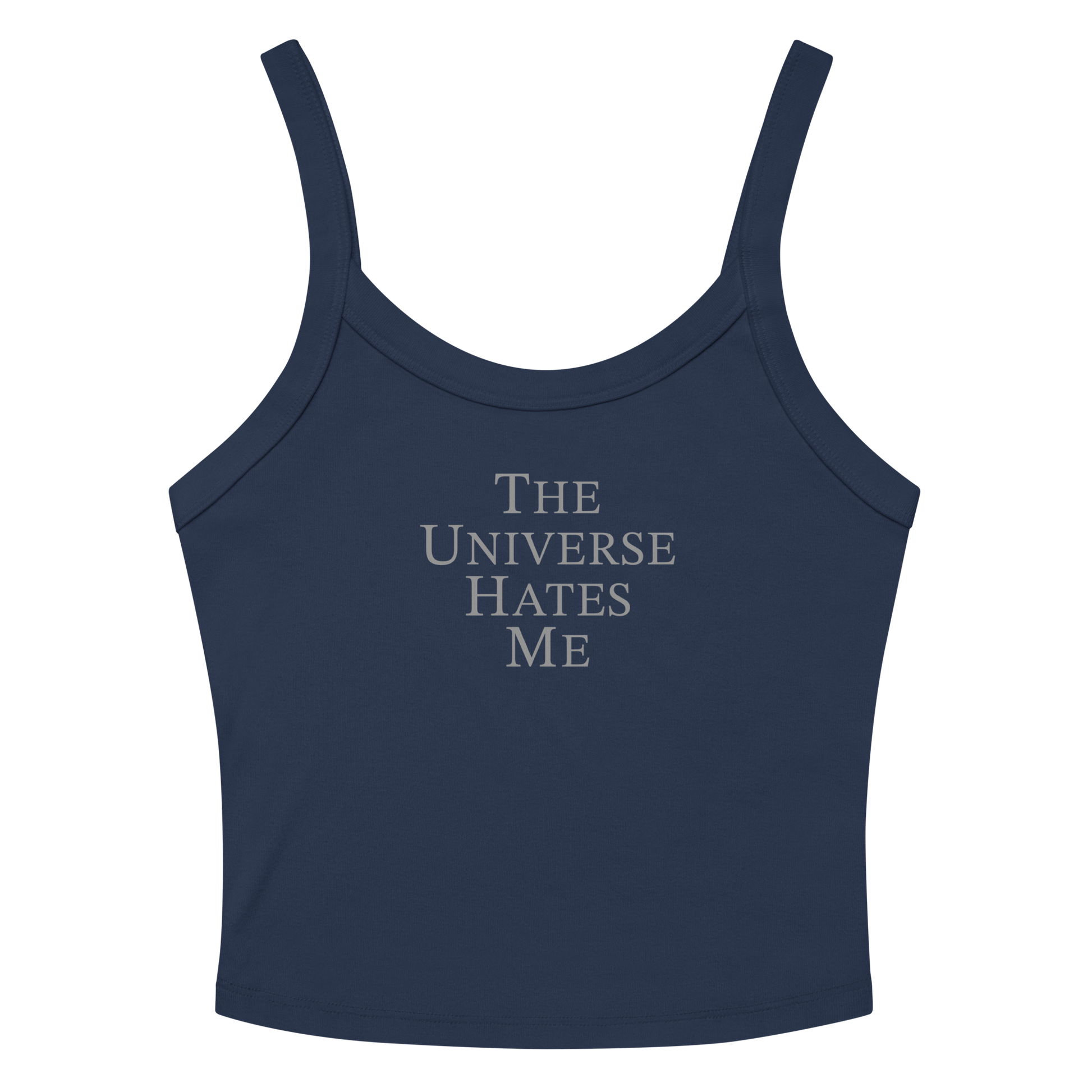 "The Universe Hates Me" printed on a solid navy blend women's micro-rib tanktop laying on a flat surface amongst sunglasses and shorts