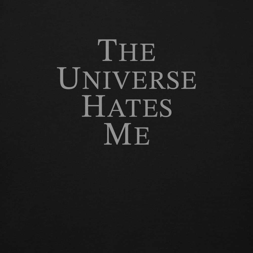 "The Universe Hates Me" printed on a black background