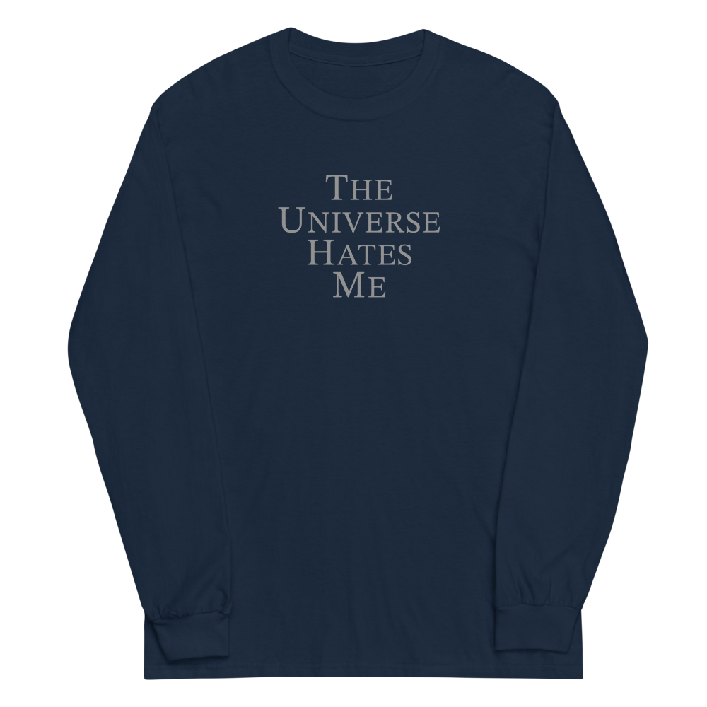 "The Universe Hates Me" printed on a navy men's long sleeve shirt laying on a flat surface