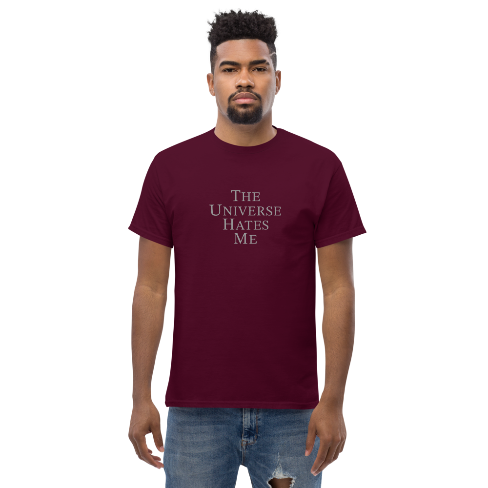 "The Universe Hates Me" printed on a maroon unisex classic tee worn by a male