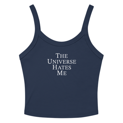 "The Universe Hates Me" printed on a solid navy blend women's micro-rib tanktop laying on a flat surface amongst sunglasses and shorts