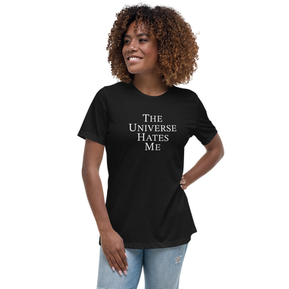 "The Universe Hates Me" printed on a black women's relaxed t-shirt worn by a female