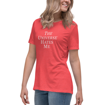 "The Universe Hates Me" printed on a heather red women's relaxed t-shirt worn by a female
