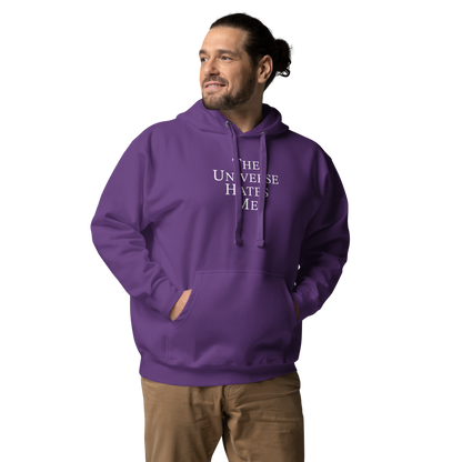 "The Universe Hates Me" printed on a purple unisex hoodie worn by a male