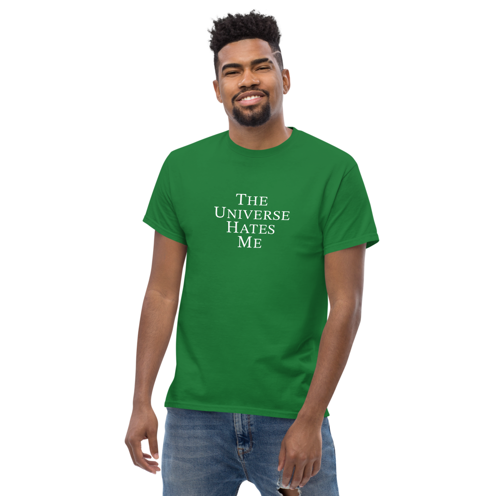 "The Universe Hates Me" printed on a turf green unisex classic tee worn by a male