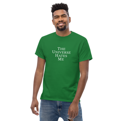 "The Universe Hates Me" printed on a turf green unisex classic tee worn by a male