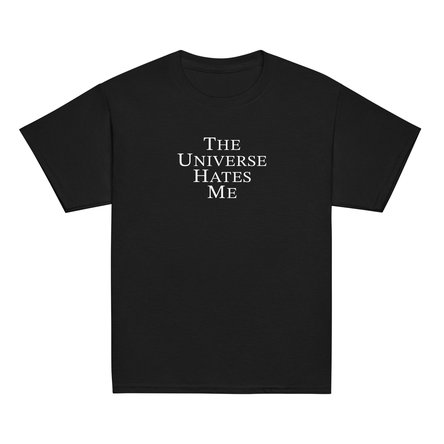 "The Universe Hates Me" printed on a black youth classic tee laying on a flat surface