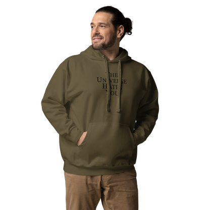 "The Universe Hates You" printed on a military green unisex hoodie worn by a male