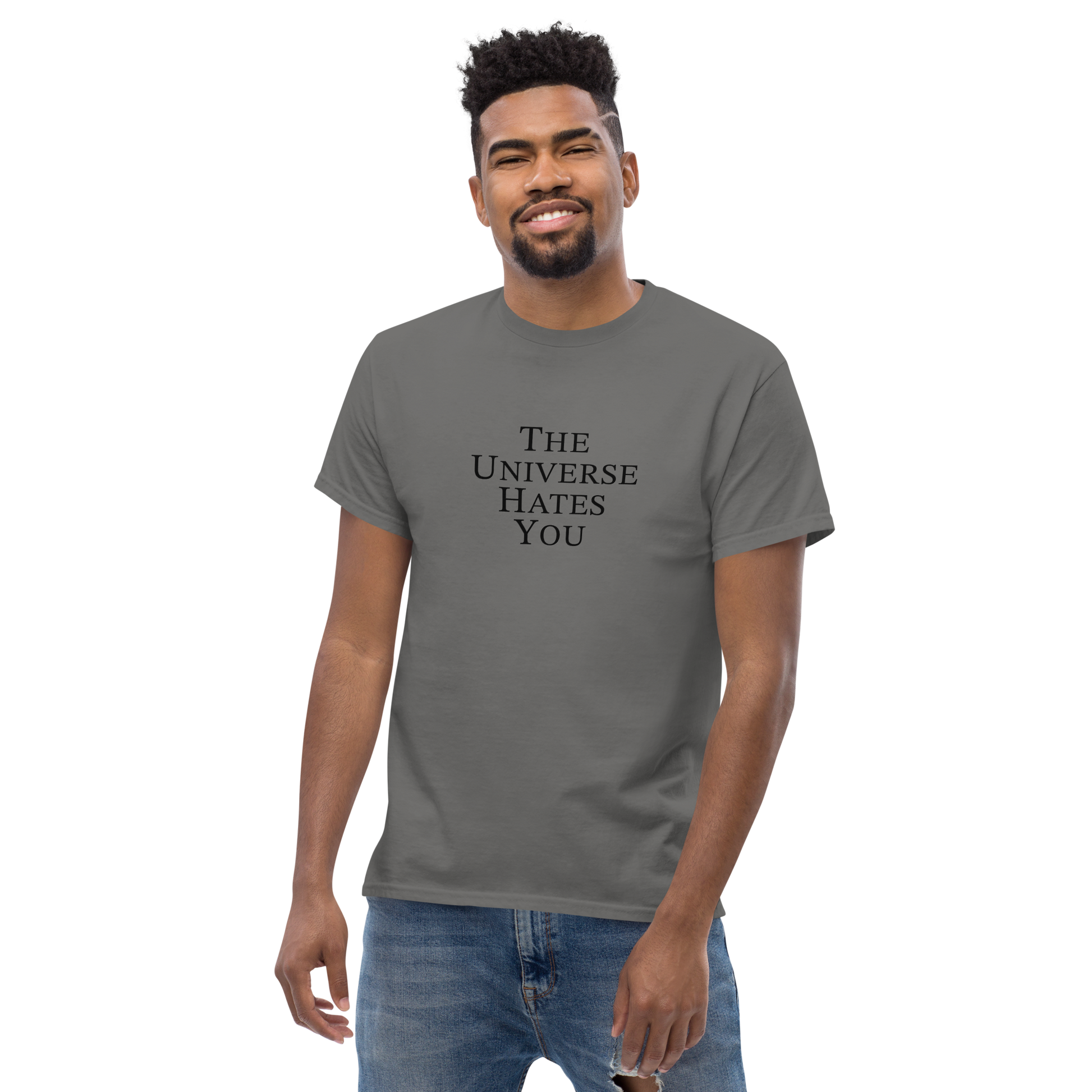 "The Universe Hates You" printed on a charcoal unisex classic tee worn by a male