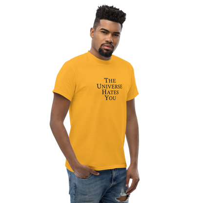 "The Universe Hates You" printed on a gold unisex classic tee worn by a male