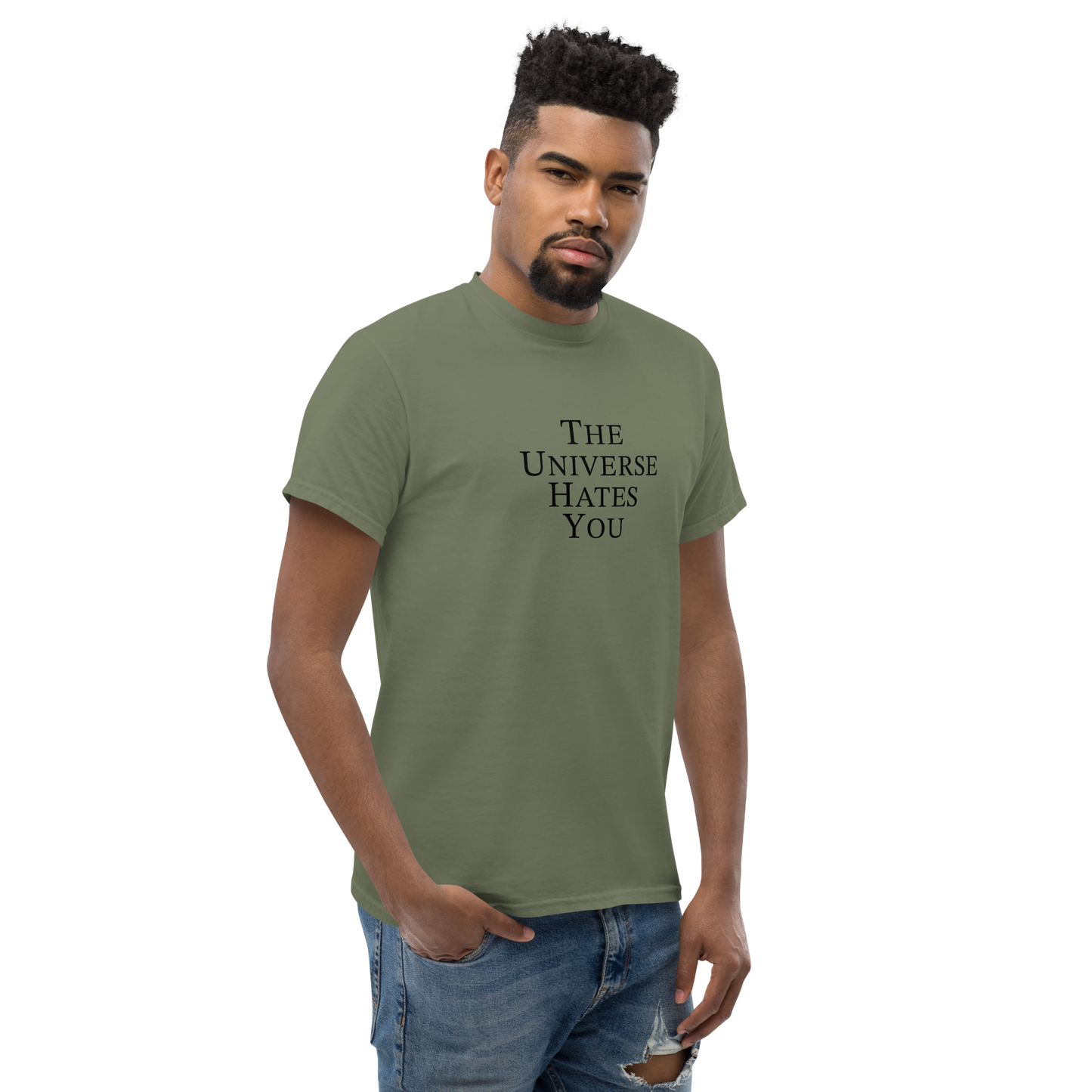 "The Universe Hates You" printed on a military green unisex classic tee worn by a male