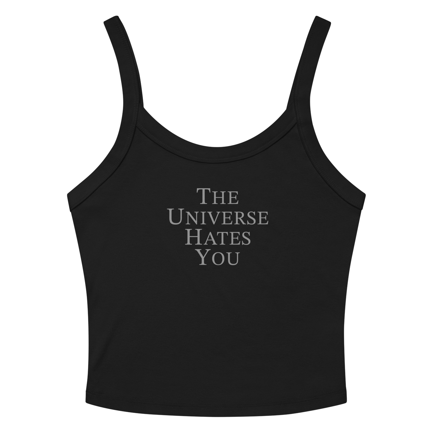 "The Universe Hates You" printed on a solid black blend women's micro-rib tanktop laying on a flat surface amongst sunglasses and shorts
