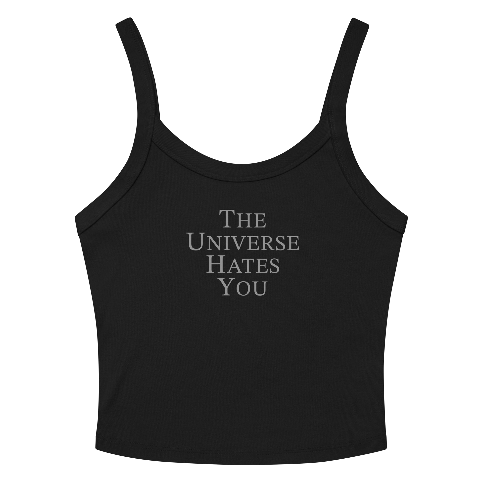 "The Universe Hates You" printed on a solid black blend women's micro-rib tanktop laying on a flat surface amongst sunglasses and shorts