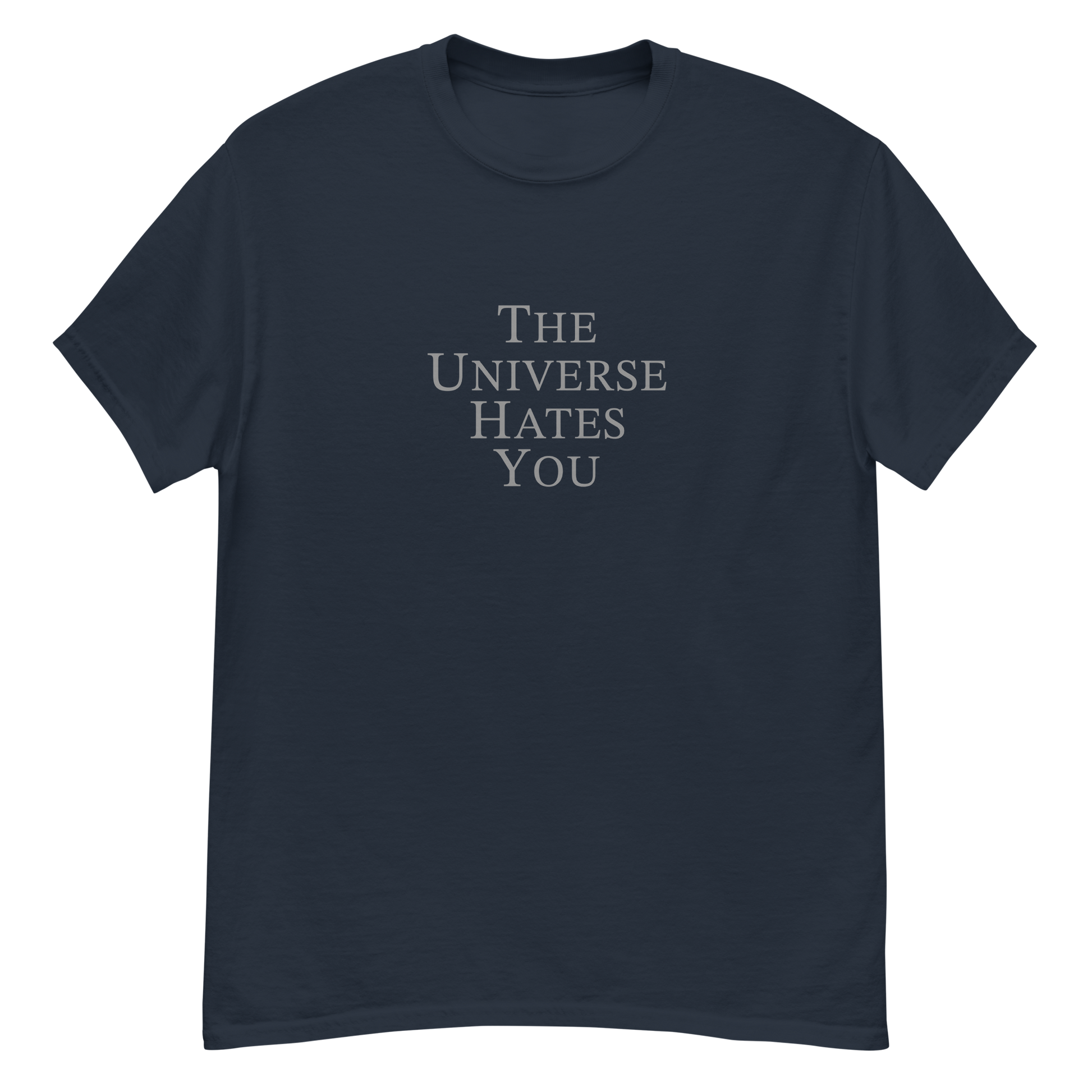 "The Universe Hates You" printed on a navy unisex classic tee laying on a flat surface