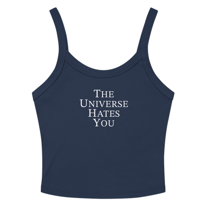 "The Universe Hates You" printed on a solid navy blend women's micro-rib tanktop laying on a flat surface amongst sunglasses and shorts