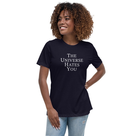 "The Universe Hates You" printed on a navy women's relaxed t-shirt worn by a female