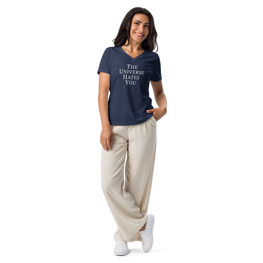 "The Universe Hates You" printed on a heather navy women's relaxed v-neck t-shirt worn by a female