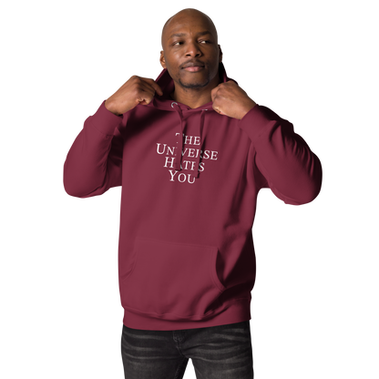 "The Universe Hates You" printed on a maroon unisex hoodie worn by a male