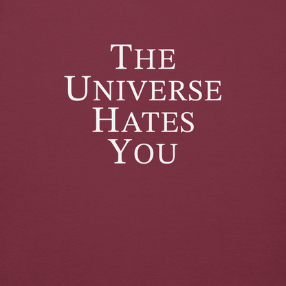 "The Universe Hates You" printed on a maroon background