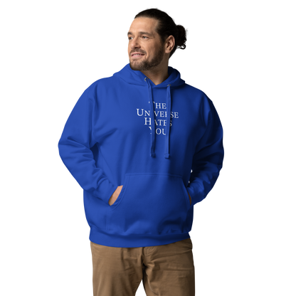 "The Universe Hates You" printed on a team royal unisex hoodie worn by a male