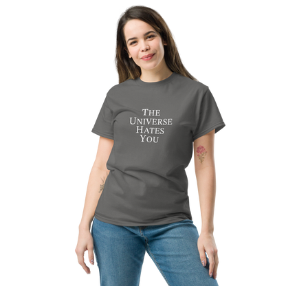 "The Universe Hates You" printed on a charcoal unisex classic tee worn by a female
